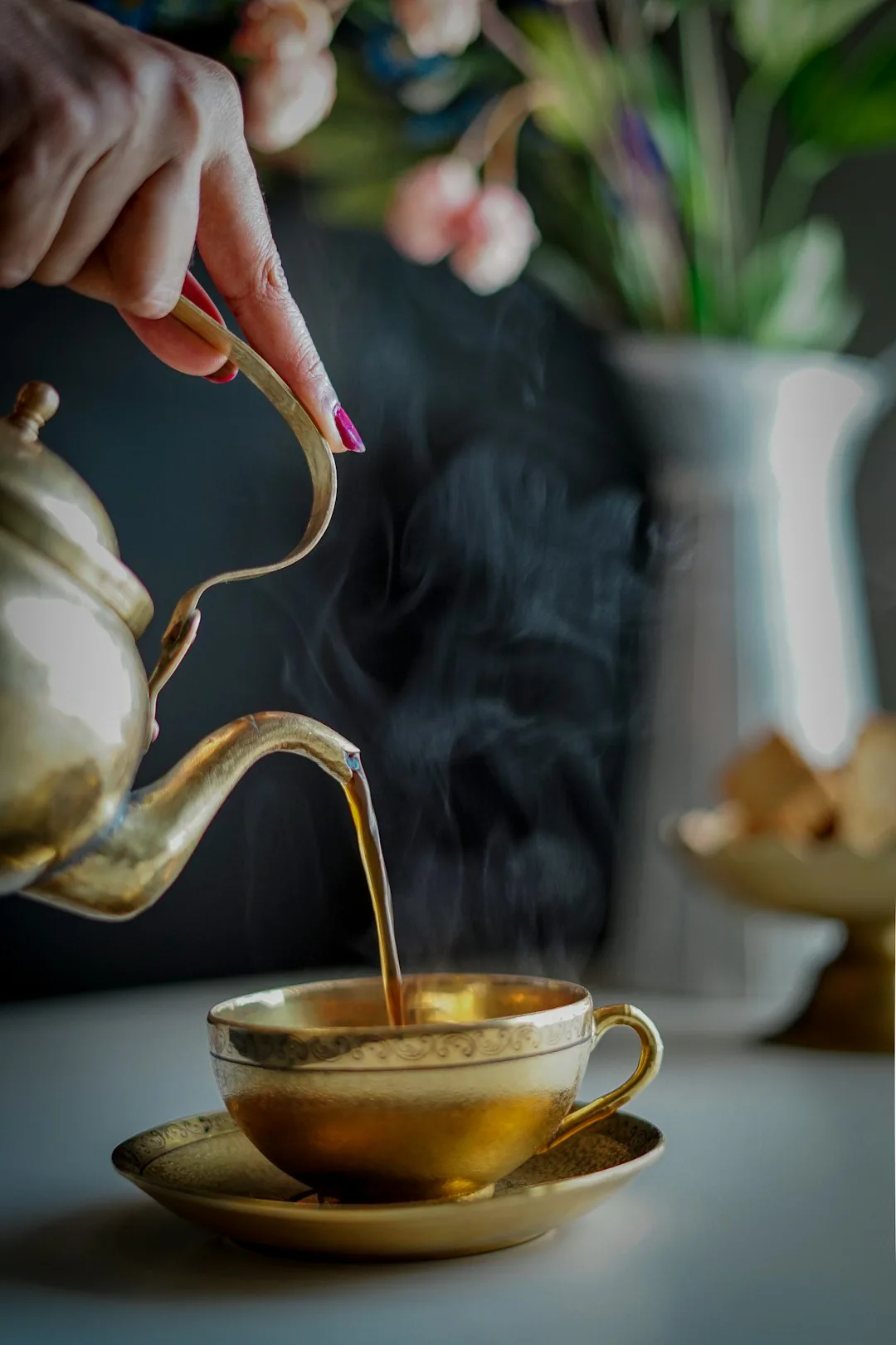 Portrait of guide Rin Sato pouring tea at a clearing